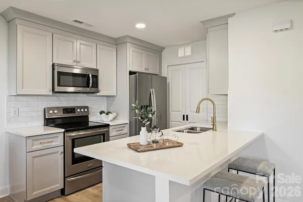 a kitchen with a sink a stove and refrigerator