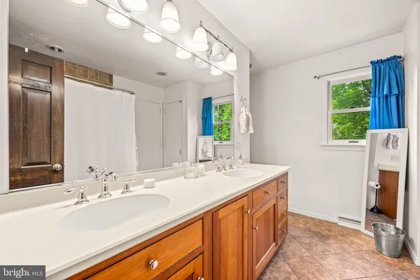 a bathroom with a sink double vanity and a mirror