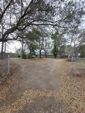 a view of a field with trees in the background