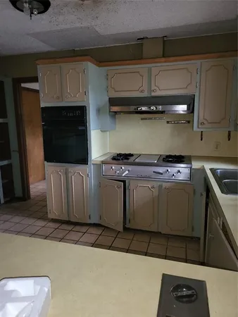 a kitchen with a stove and a microwave