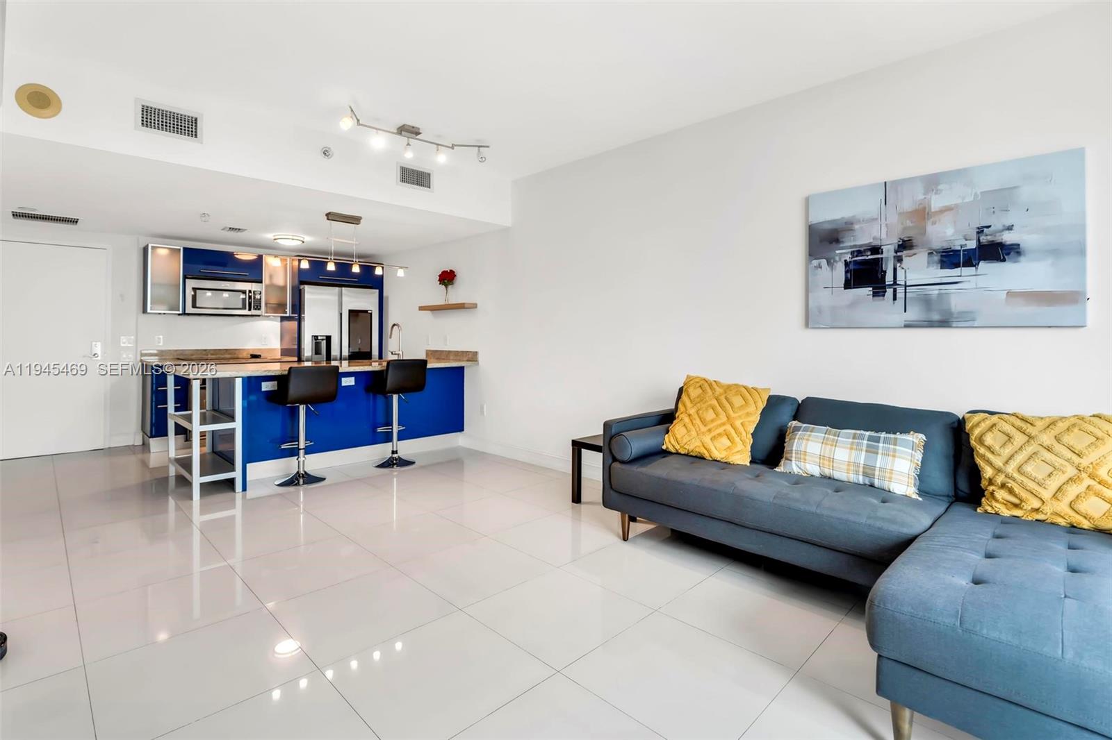 185 Southwest 7th Street, Unit 3508 Miami, FL 33130 - Photo 11 of 62 a living room with furniture and kitchen view