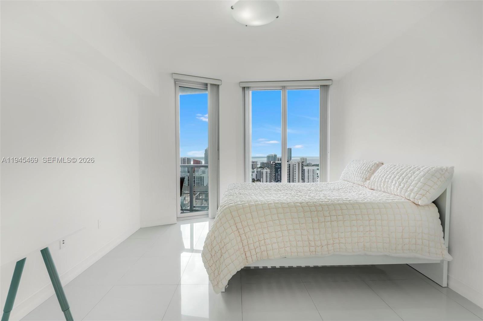 185 Southwest 7th Street, Unit 3508 Miami, FL 33130 - Photo 17 of 62 a bedroom with a bed and window