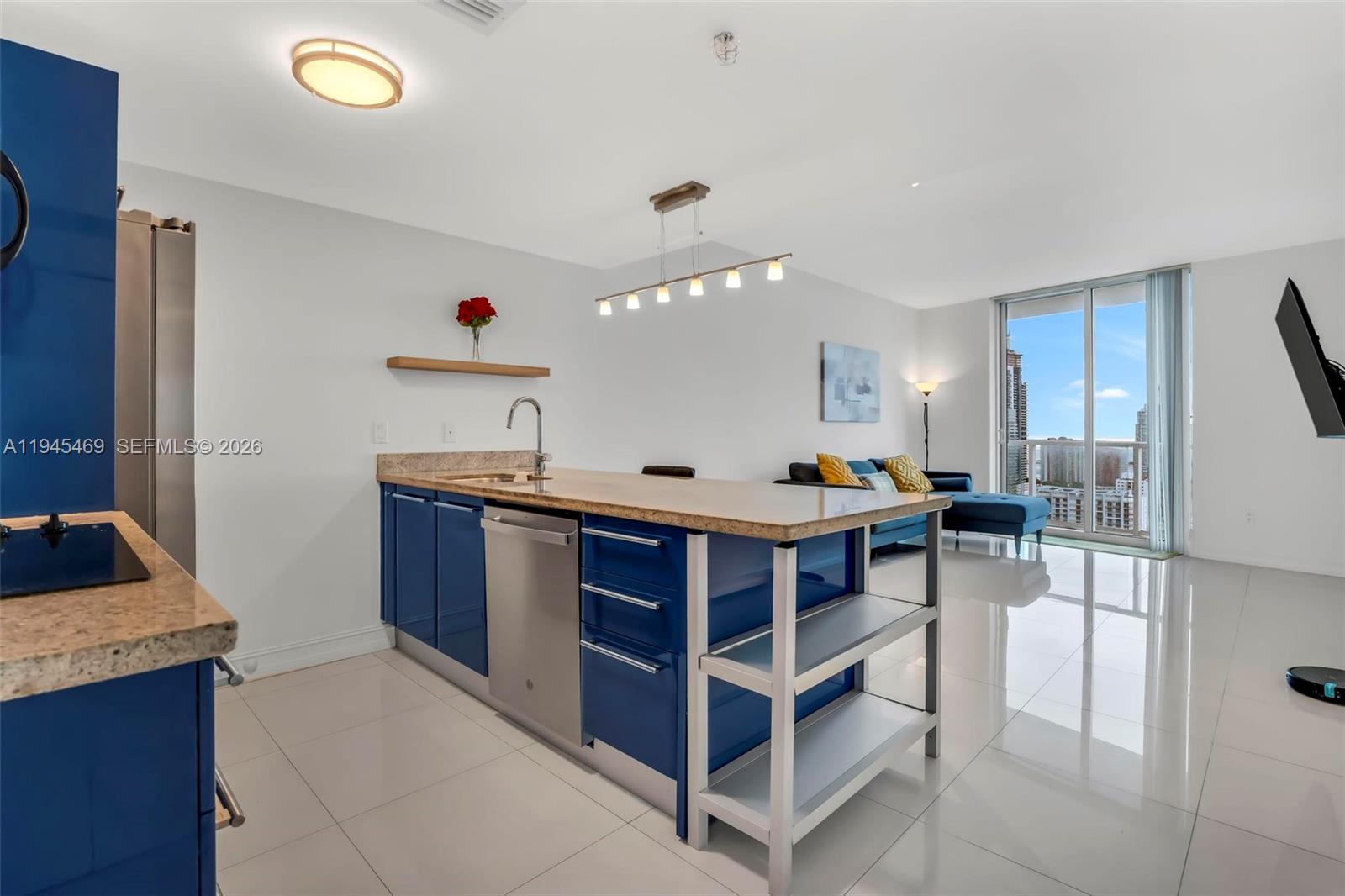 185 Southwest 7th Street, Unit 3508 Miami, FL 33130 - Photo 3 of 62 a open kitchen with stainless steel appliances kitchen island granite countertop a sink and a refrigerator