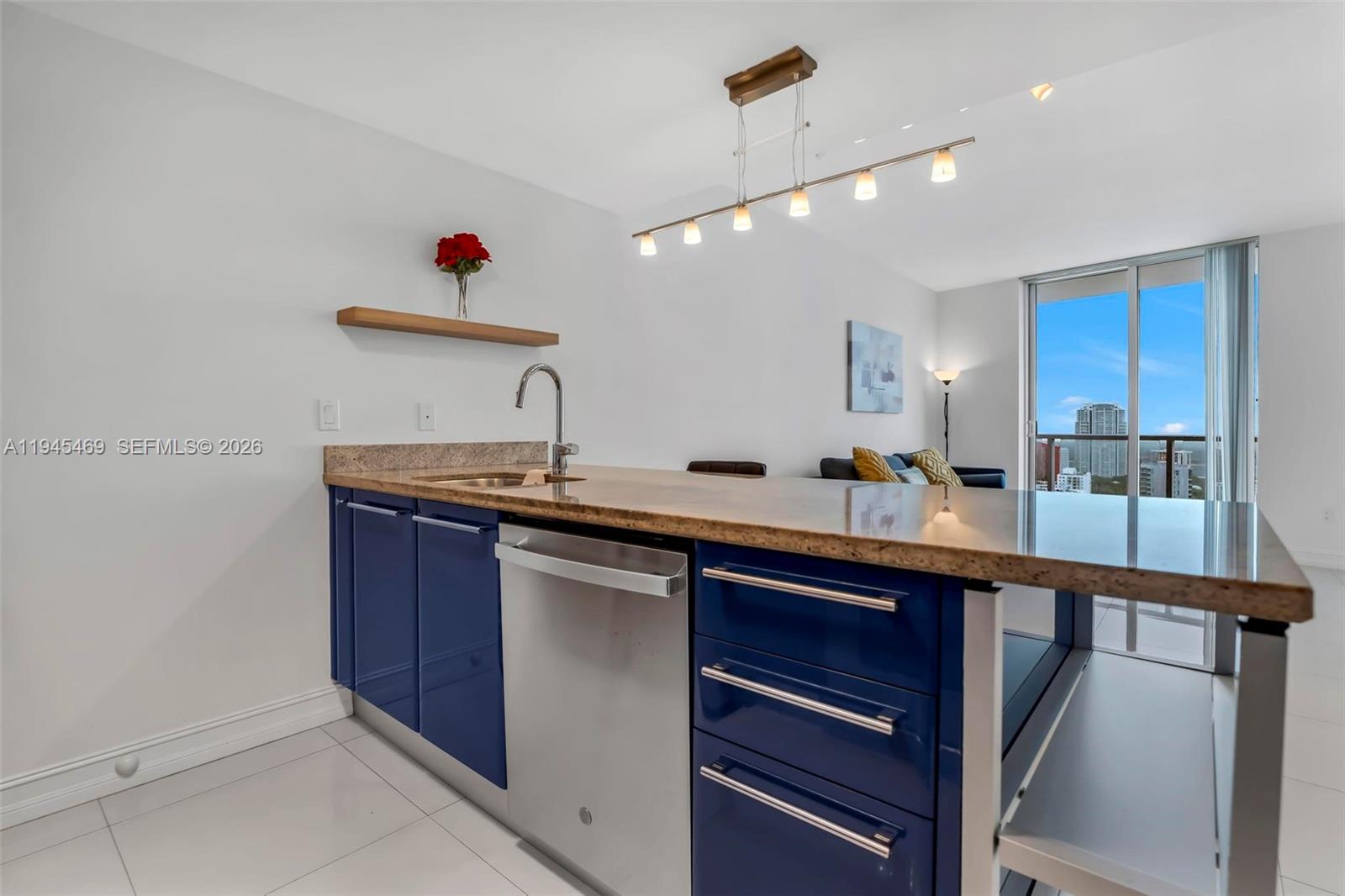 185 Southwest 7th Street, Unit 3508 Miami, FL 33130 - Photo 6 of 62 a kitchen with stainless steel appliances granite countertop a sink and cabinets