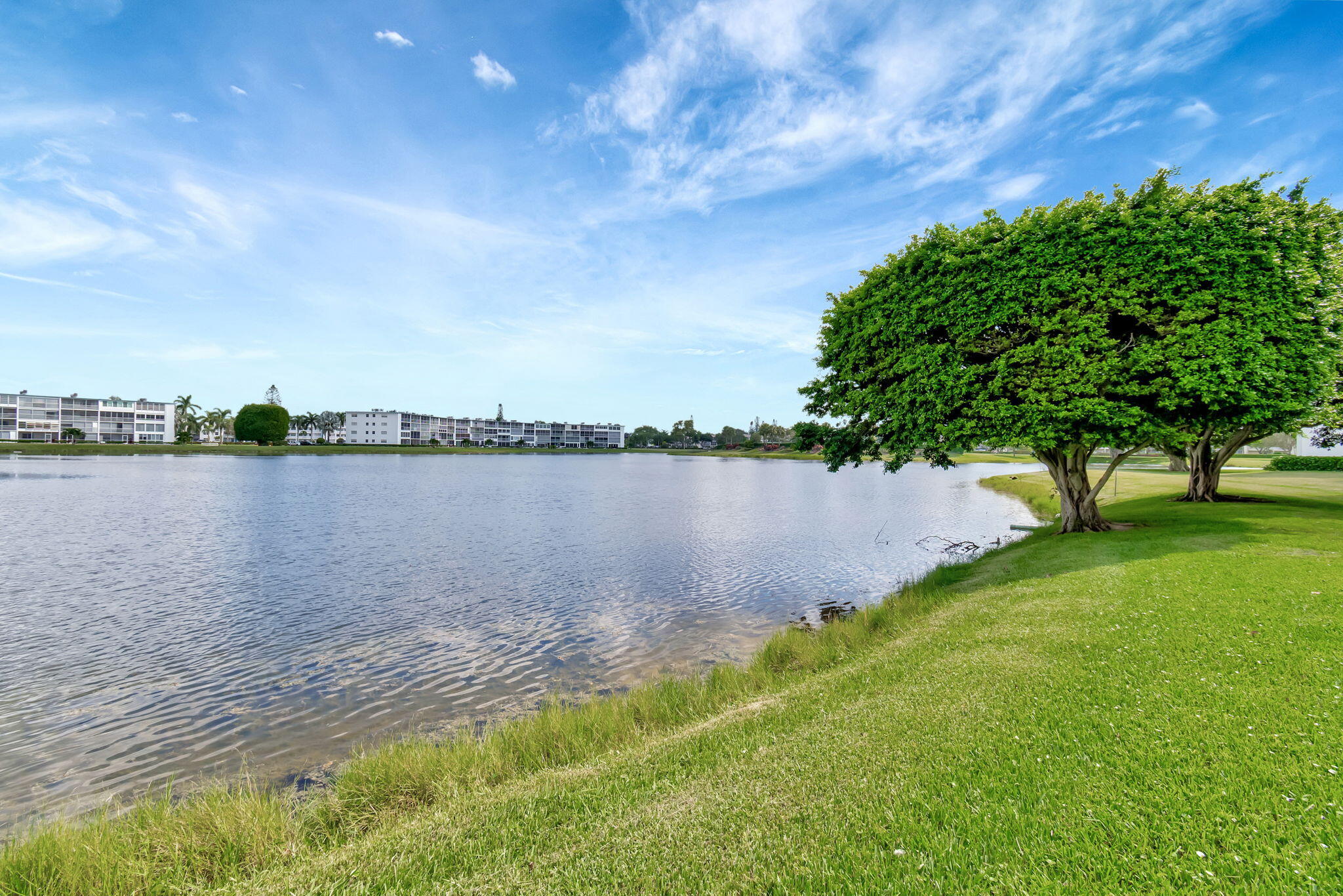 3031 Cornwall East Boca Raton, FL 33434 - Photo 35 of 84 a view of a lake with houses in the back
