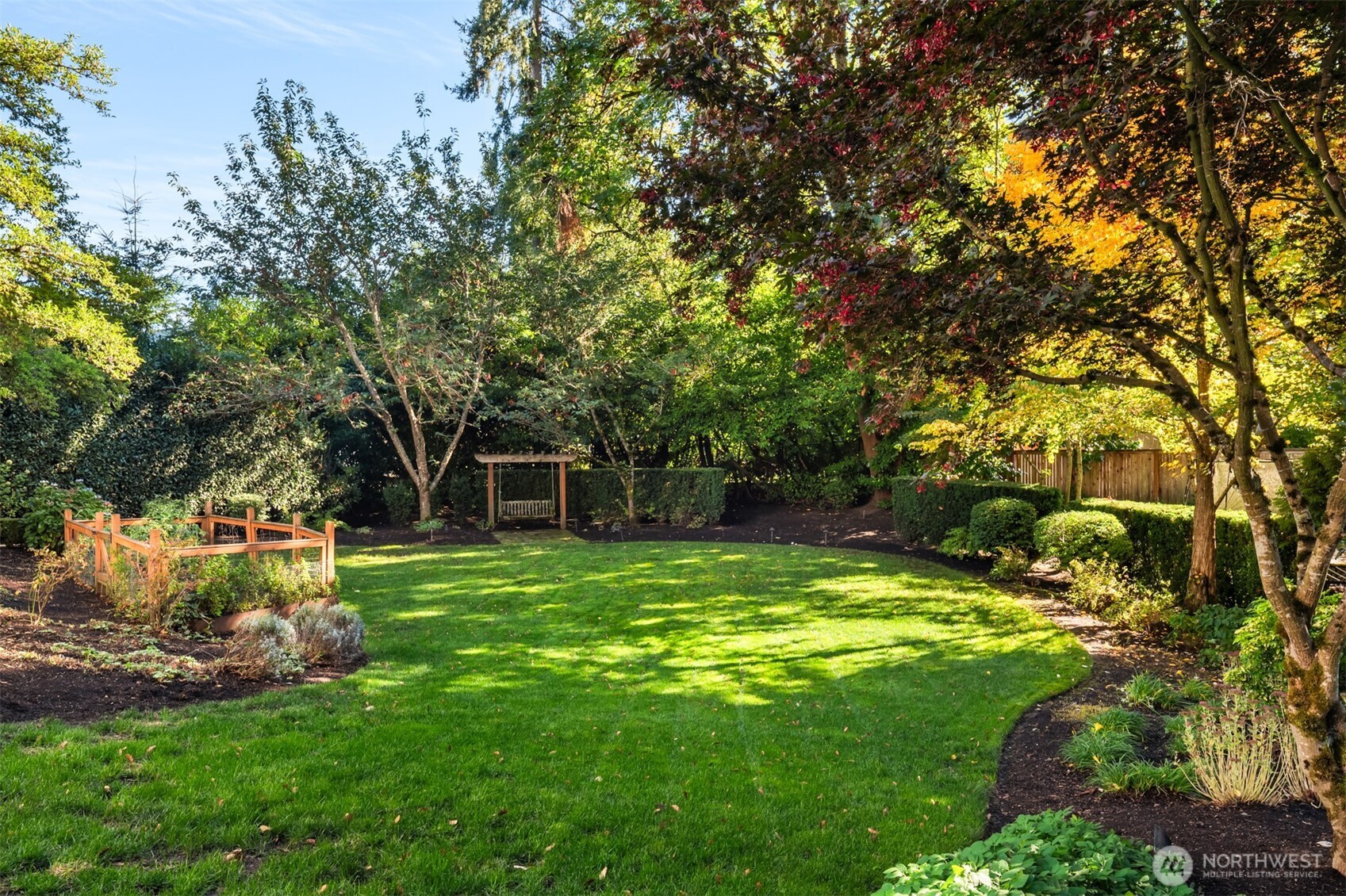 10475 Southeast 23rd Street Bellevue, WA 98004 - Photo 29 of 35 a view of a backyard with table and chairs and potted plants and large trees
