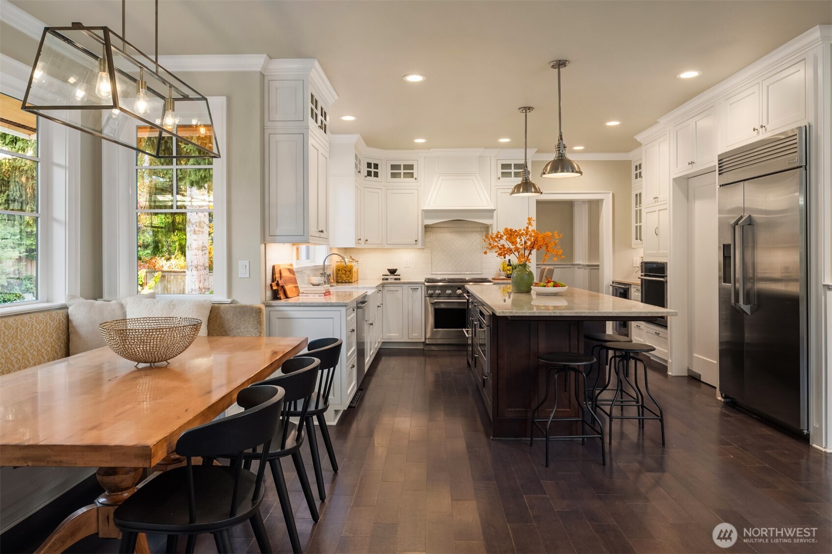 10475 Southeast 23rd Street Bellevue, WA 98004 - Photo 7 of 35 a dining room with furniture a chandelier and wooden floor