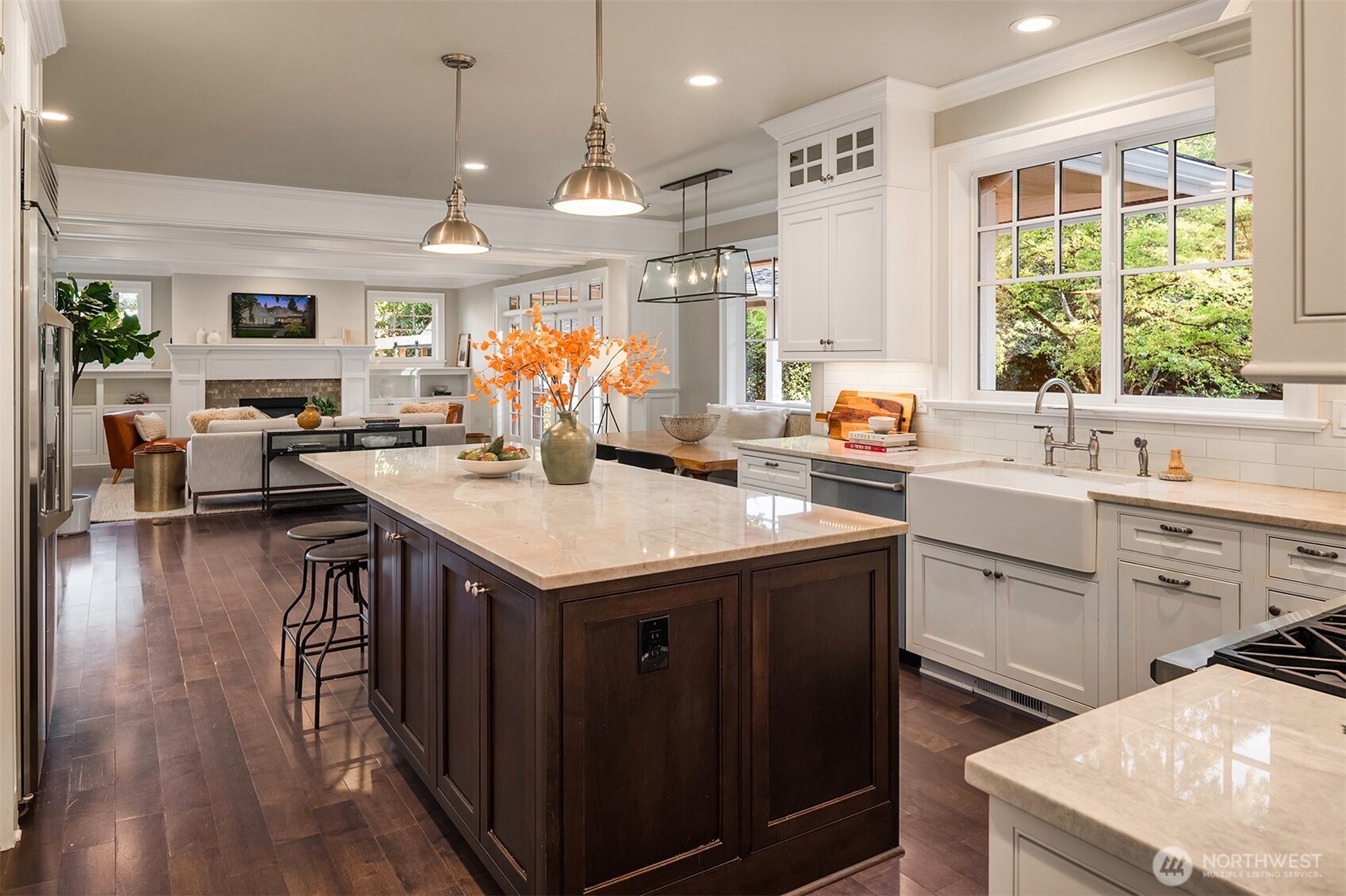 10475 Southeast 23rd Street Bellevue, WA 98004 - Photo 8 of 35 a kitchen with a stove a sink dishwasher and a dining table with wooden floor