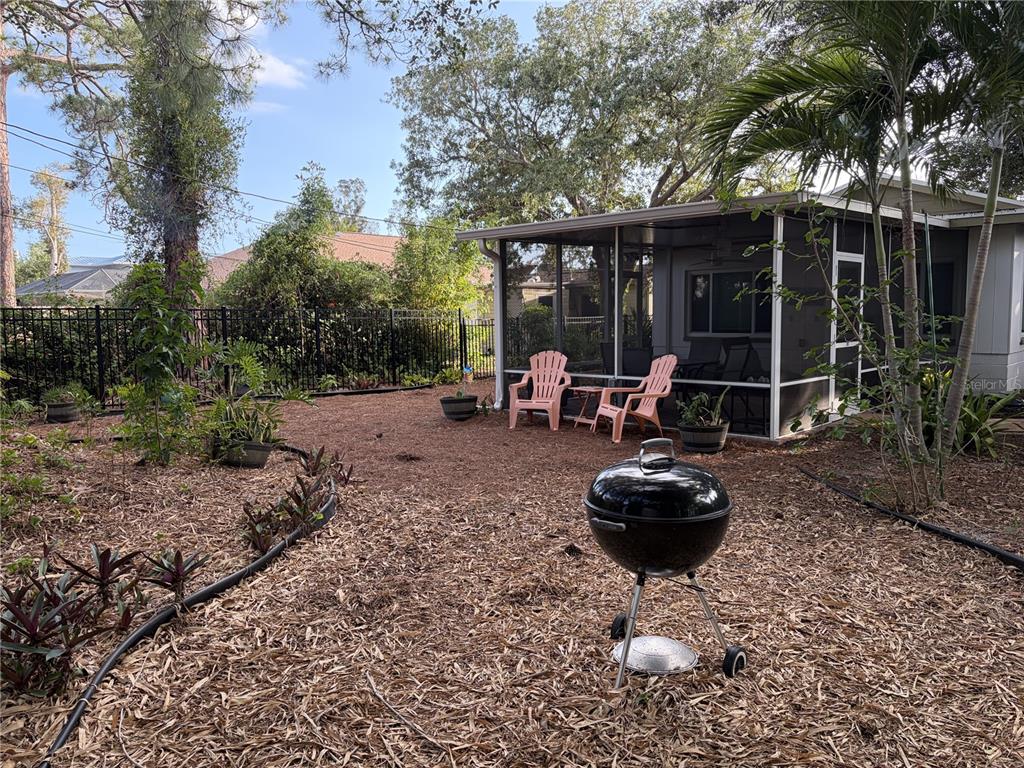 421 Riviera Street Venice, FL 34285 - Photo 22 of 30 a view of a chair and tables in backyard