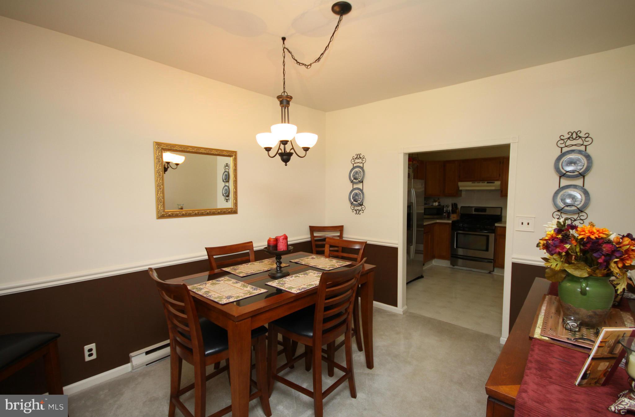 364 Nicholson Road Baltimore, MD 21221 - Photo 11 of 30 a view of a dining room with furniture and chandelier