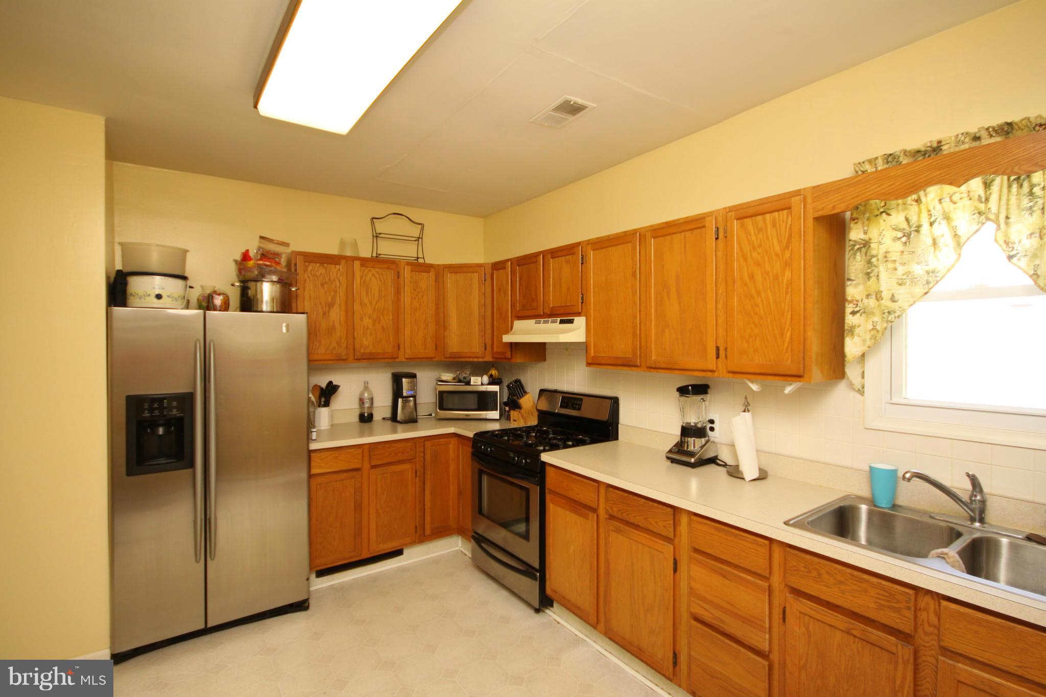 364 Nicholson Road Baltimore, MD 21221 - Photo 12 of 30 a kitchen with stainless steel appliances granite countertop a refrigerator a sink a stove and island
