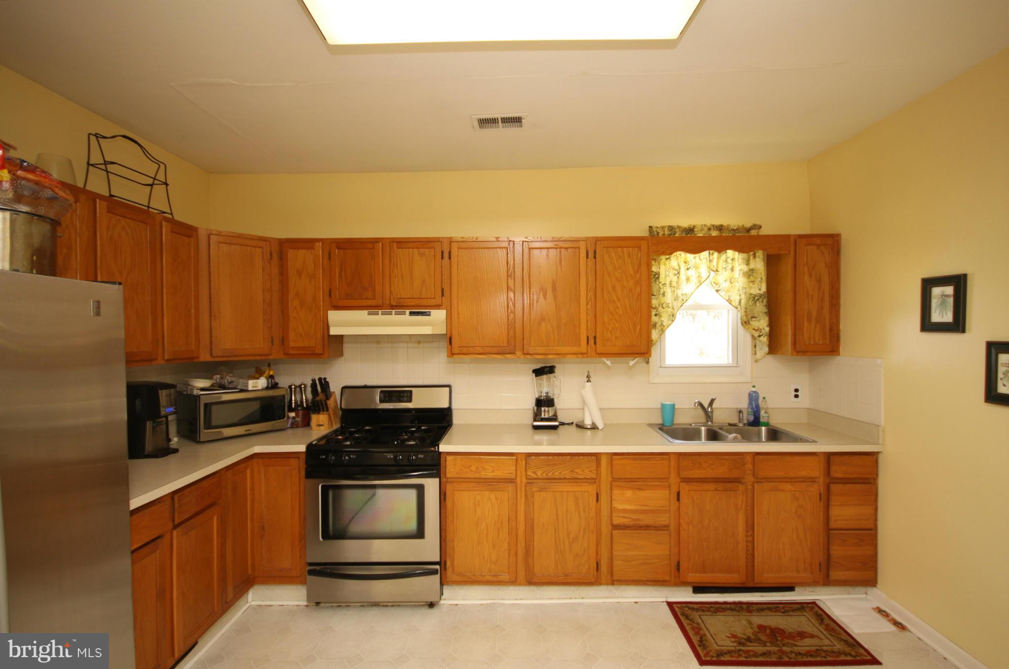 364 Nicholson Road Baltimore, MD 21221 - Photo 13 of 30 a kitchen with stainless steel appliances a stove a sink and a microwave