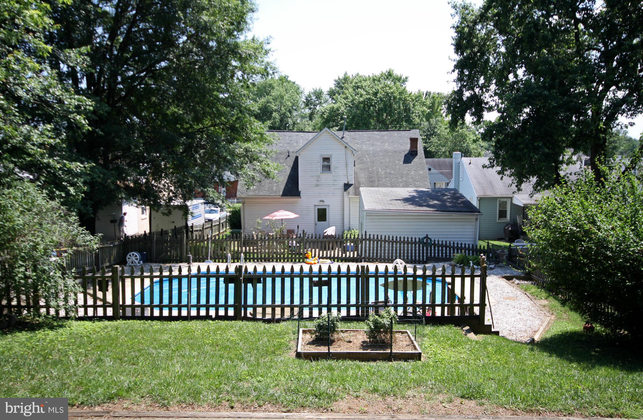 364 Nicholson Road Baltimore, MD 21221 - Photo 24 of 30 a front view of a house with a garden