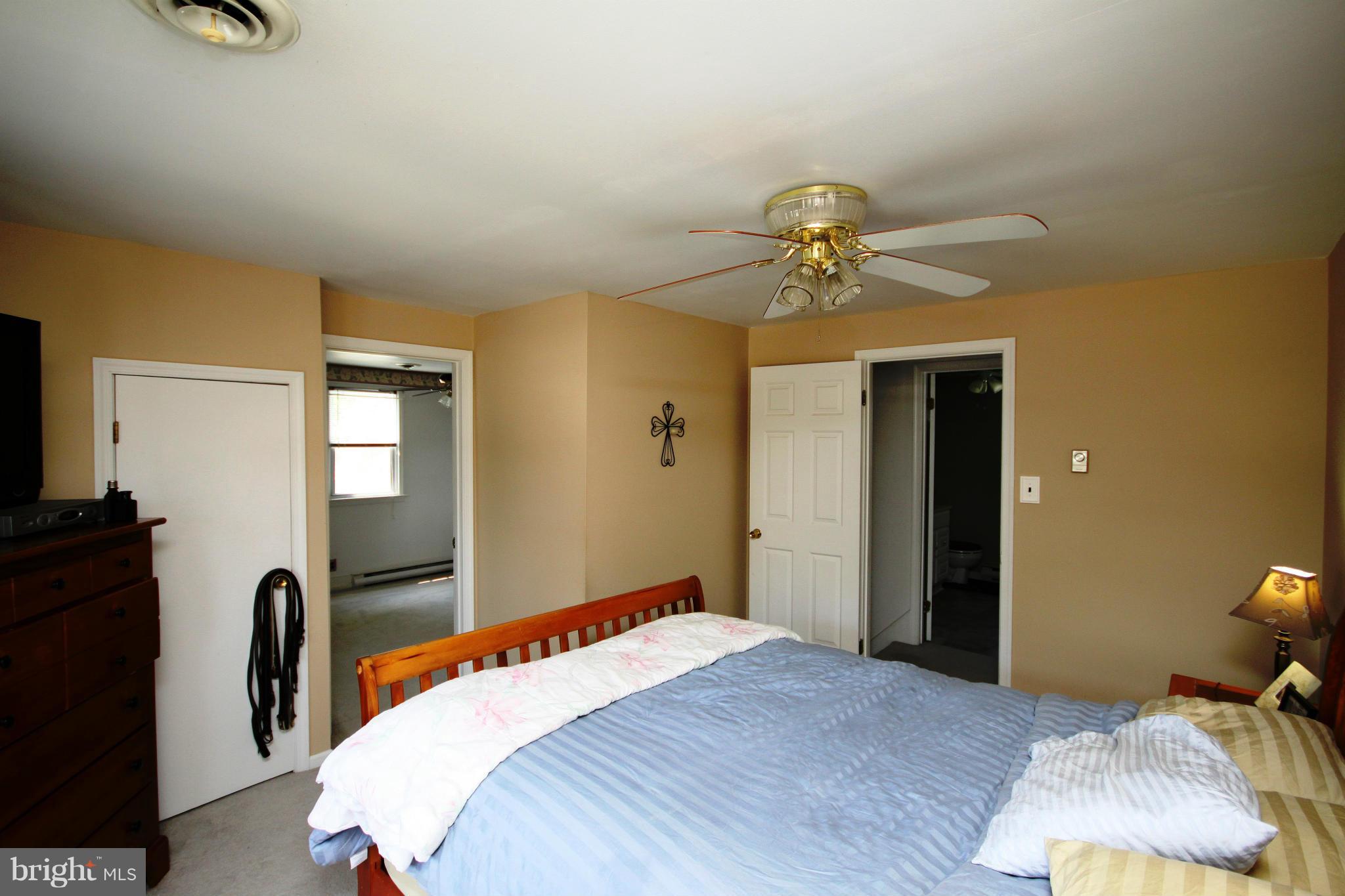 364 Nicholson Road Baltimore, MD 21221 - Photo 7 of 30 a bedroom with a bed and a chandelier