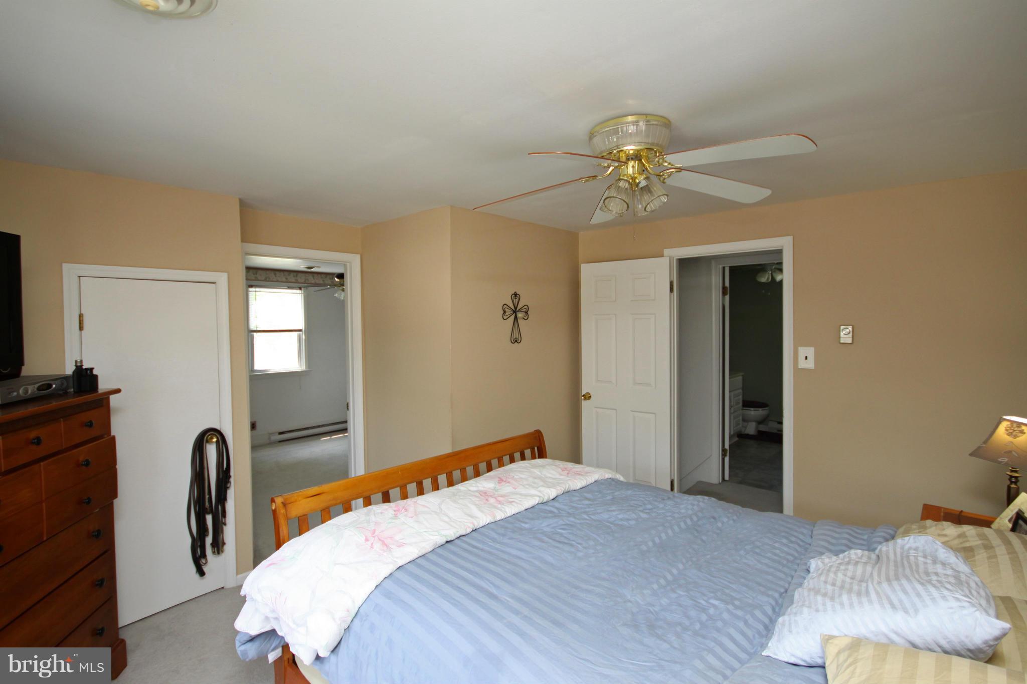 364 Nicholson Road Baltimore, MD 21221 - Photo 8 of 30 a bedroom with a bed and a chandelier