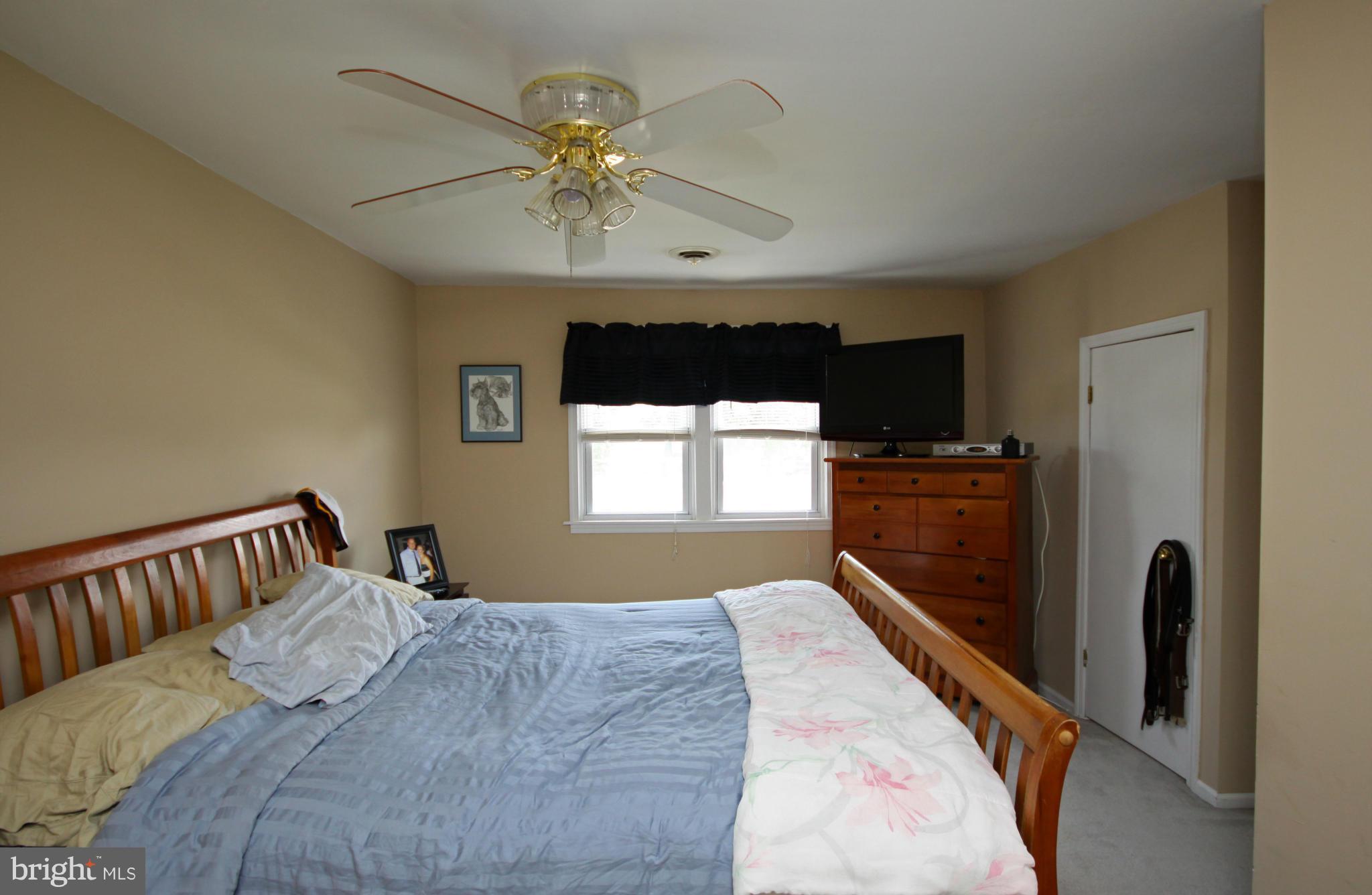 364 Nicholson Road Baltimore, MD 21221 - Photo 9 of 30 a bedroom with a bed and a chandelier