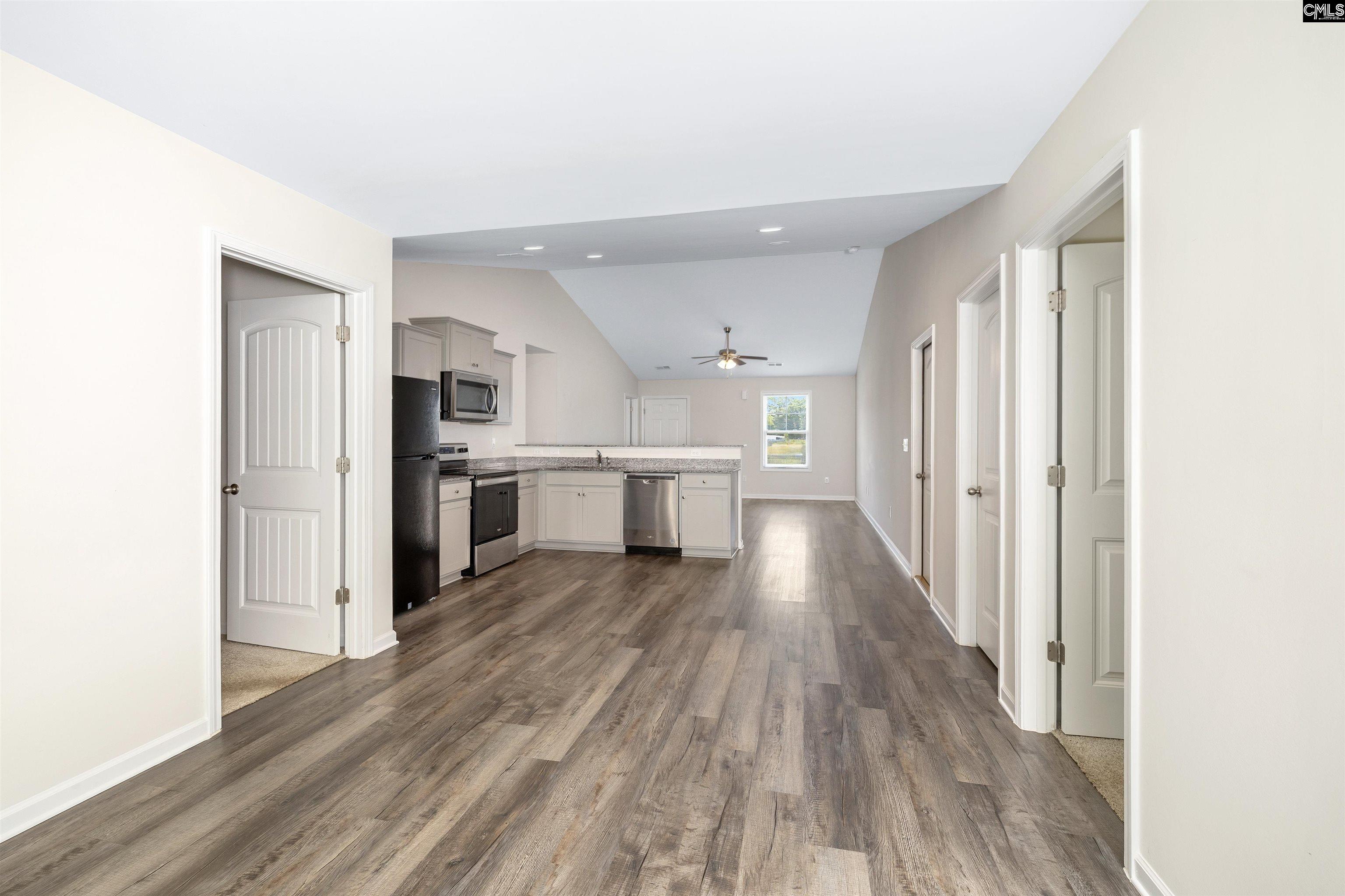 2157 Still Pointe Drive Sumter, SC 29154 - Photo 15 of 25 a view of a kitchen with wooden floor electronic appliances and stairs