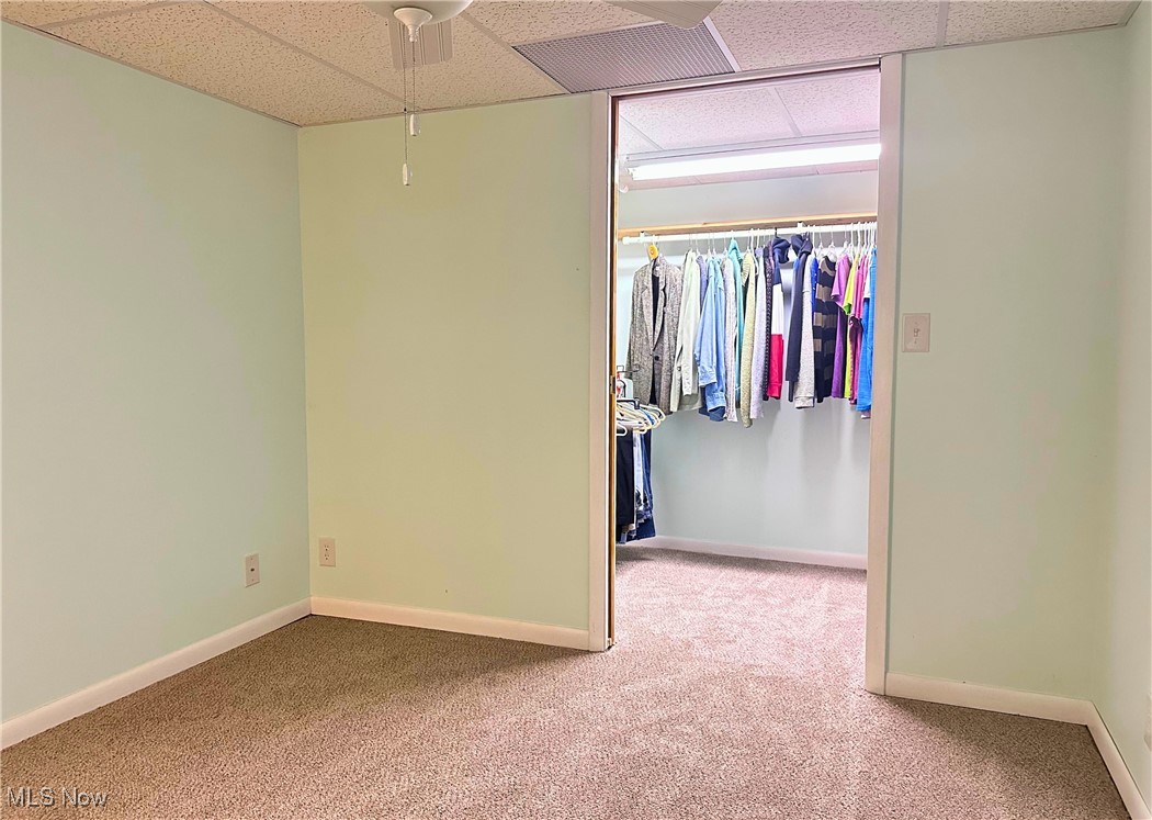 157 Birch Road Painesville, OH 44077 - Photo 25 of 41 Unfurnished basement bedroom-type room featuring a drop ceiling, carpet floors, a closet, and baseboards