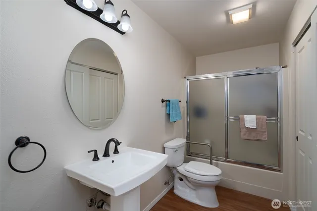a bathroom with a toilet a sink and a mirror