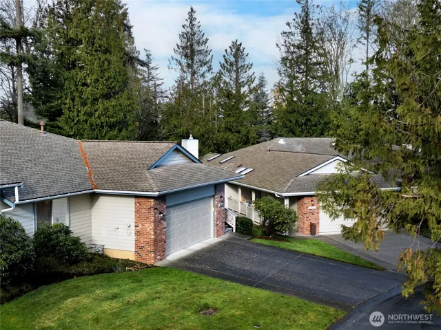 a aerial view of a house with a yard and tree s
