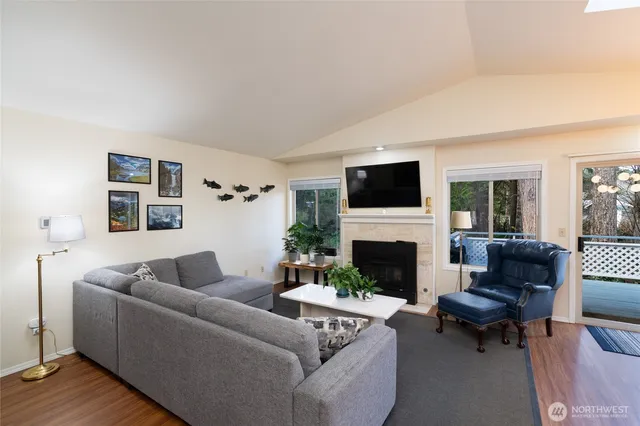 a living room with furniture a fireplace and a flat screen tv