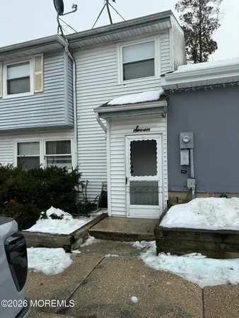 a view of a house with a yard and furniture