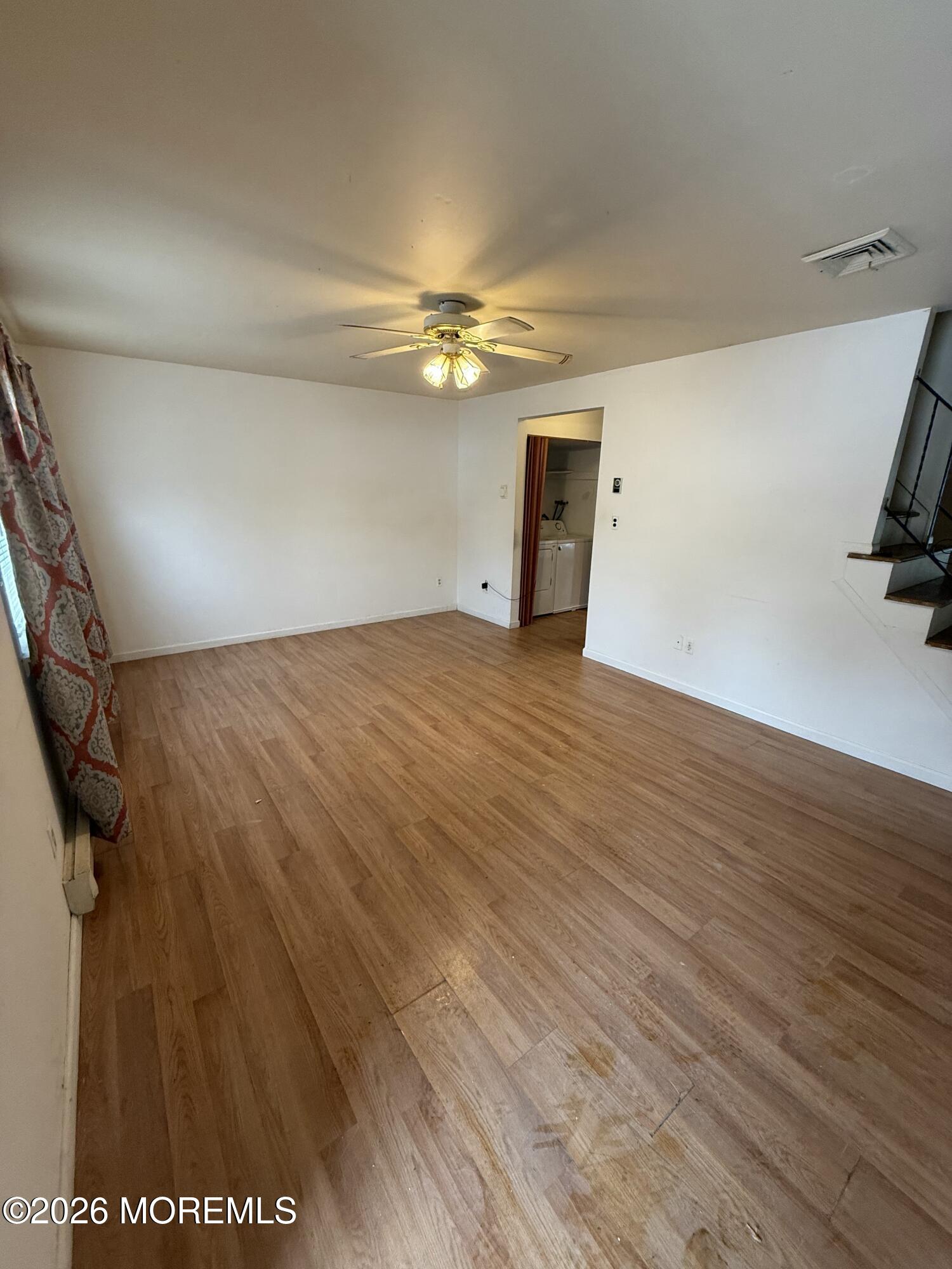 7 Sovereign Road Barnegat, NJ 08005 - Photo 4 of 7 a view of empty room with wooden floor and ceiling fan