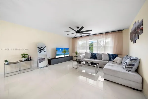 a living room with furniture and a large window