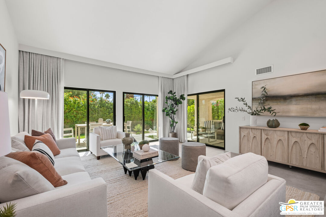 200 East Racquet Club Road, Unit 16 Palm Springs, CA 92262 - Photo 1 of 36 a living room with furniture and large windows