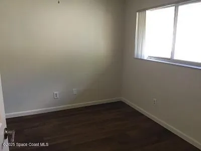 a bathroom with a toilet and a shower curtain
