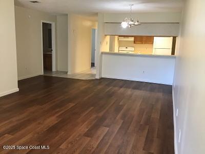 935 Prosperity Place, Unit 803 Rockledge, FL 32955 - Photo 8 of 17 an empty room with wooden floor and windows