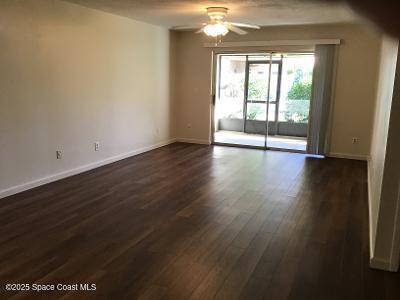 935 Prosperity Place, Unit 803 Rockledge, FL 32955 - Photo 9 of 17 a view of an empty room with wooden floor and a window