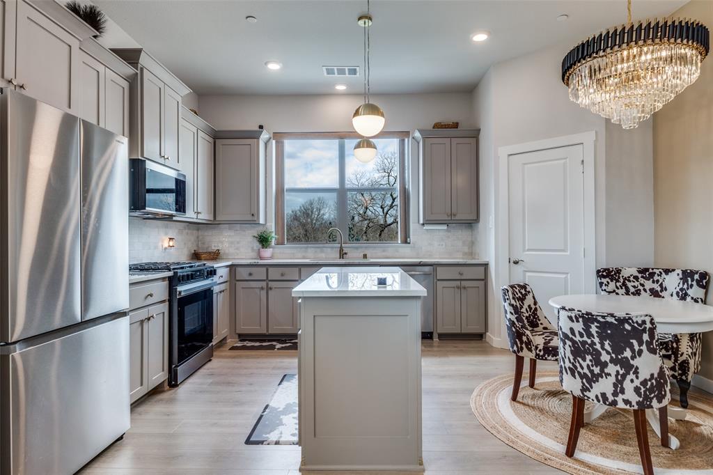 12420 Audubon Trail Rowlett, TX 75098 - Photo 9 of 27 View of Kitchen and Eat-In Area with Decorative Lighting