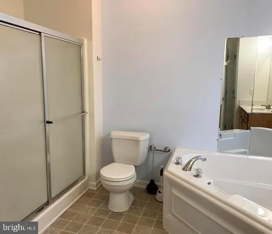 a white toilet sitting next to a bathroom sink