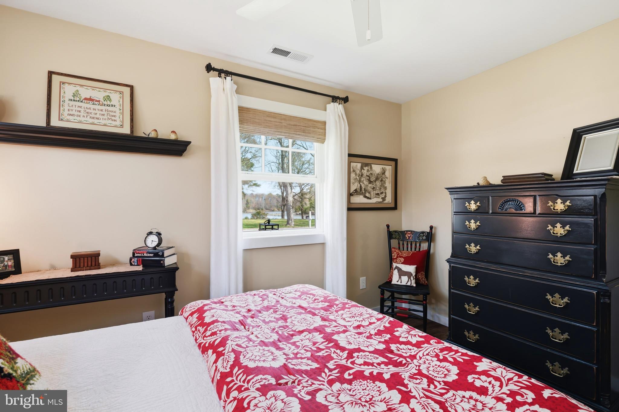 28567 Holden Road Easton, MD 21601 - Photo 34 of 45 a bedroom with a bed and a dresser in it