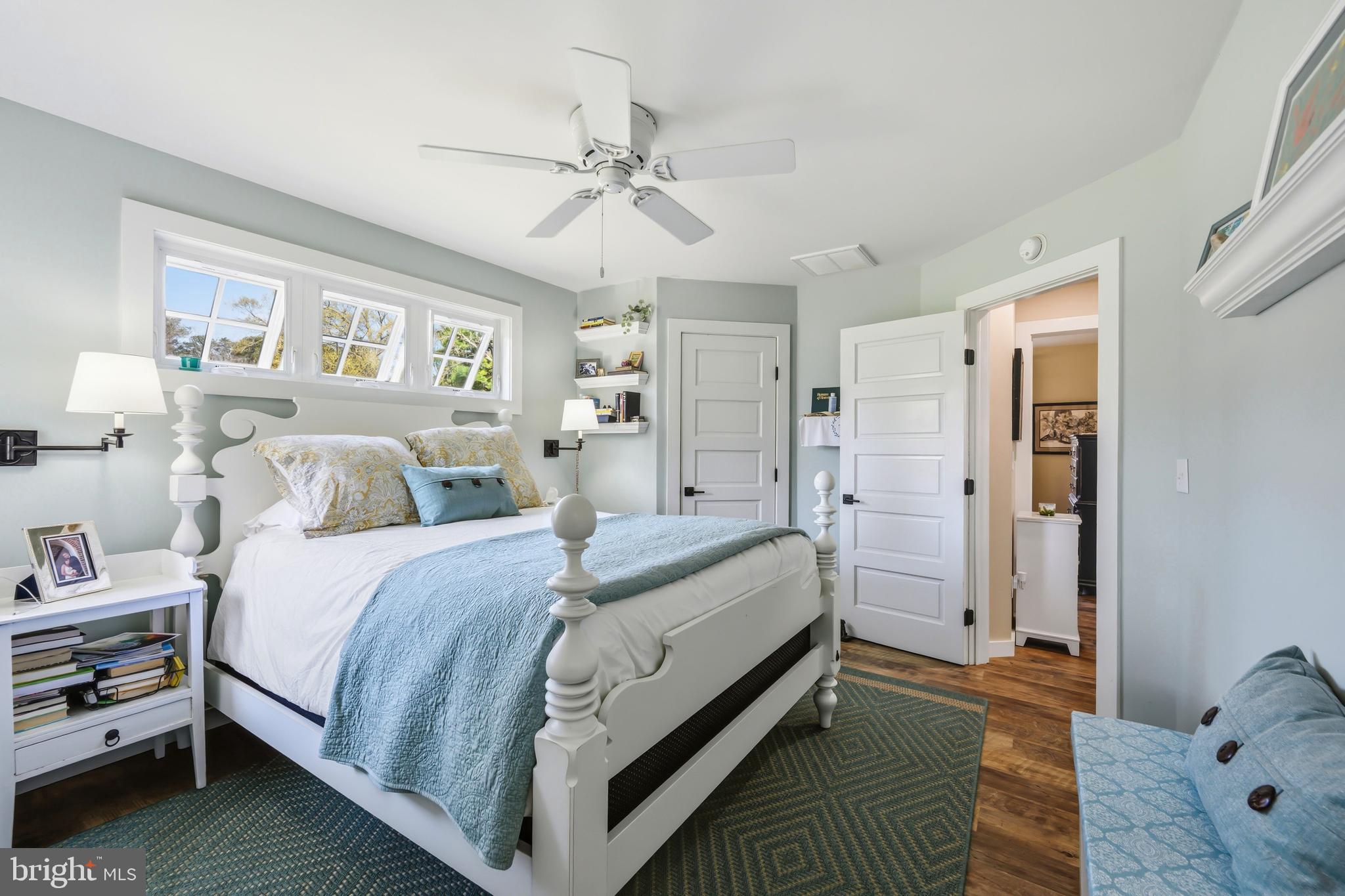 28567 Holden Road Easton, MD 21601 - Photo 37 of 45 a spacious bedroom with a bed and a chandelier