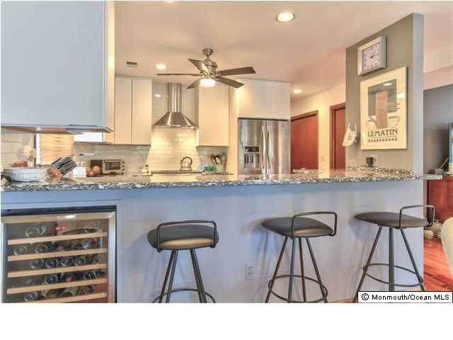 2403 River Road Point Pleasant, NJ 08742 - Photo 11 of 25 a kitchen with stainless steel appliances a sink and cabinets