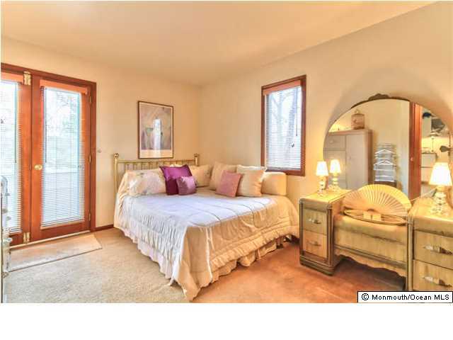 2403 River Road Point Pleasant, NJ 08742 - Photo 15 of 25 a spacious bedroom with two beds and large windows