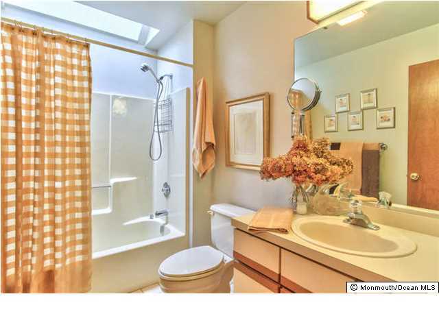 2403 River Road Point Pleasant, NJ 08742 - Photo 18 of 25 a bathroom with a sink toilet a shower and a mirror