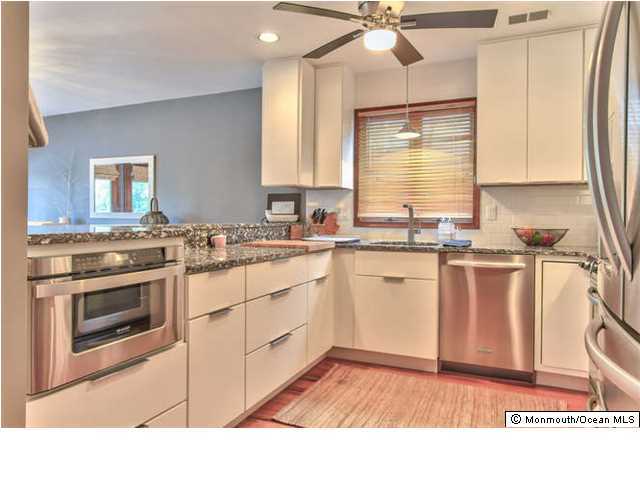 2403 River Road Point Pleasant, NJ 08742 - Photo 9 of 25 a kitchen with a stove a sink and a microwave