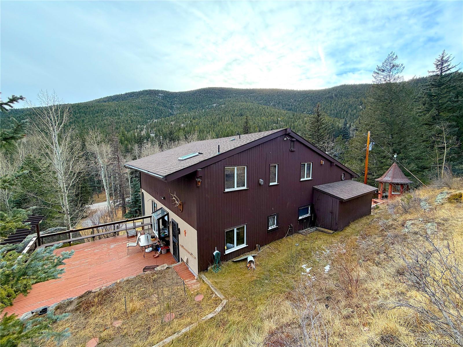 2508 Witter Gulch Road Evergreen, CO 80439 - Photo 13 of 47 a view of a house with a yard
