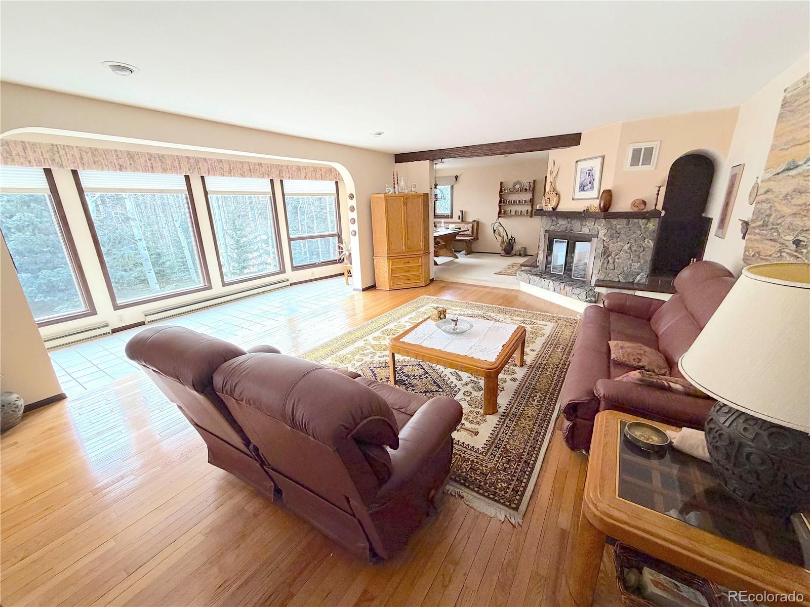 2508 Witter Gulch Road Evergreen, CO 80439 - Photo 22 of 47 a living room with furniture and a table