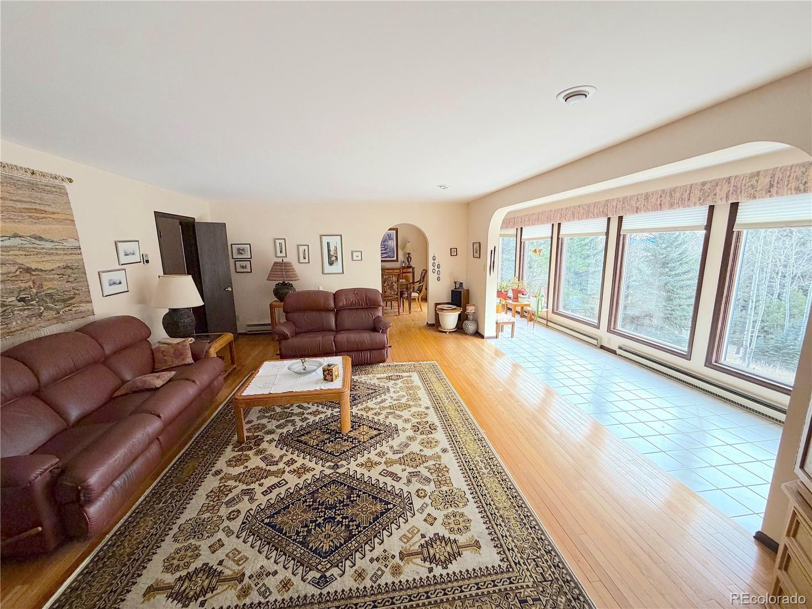 2508 Witter Gulch Road Evergreen, CO 80439 - Photo 25 of 47 a living room with furniture and a large window