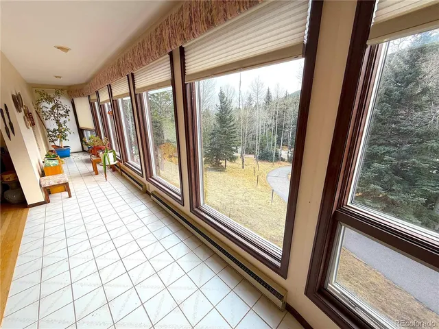 a view of a balcony with floor to ceiling windows with wooden floor