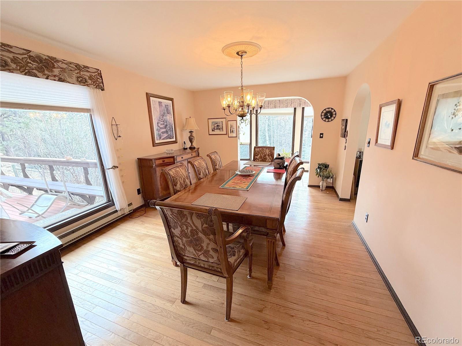 2508 Witter Gulch Road Evergreen, CO 80439 - Photo 27 of 47 a view of a dining room with furniture window and wooden floor
