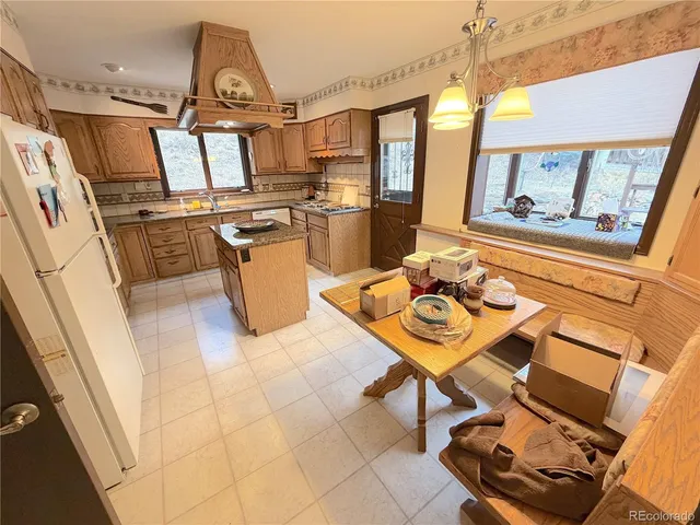 a bathroom with a granite countertop sink a mirror and shower