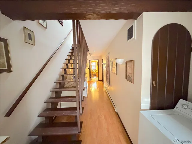 a bathroom with a granite countertop toilet a sink and a mirror