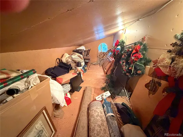 a bedroom with furniture and a large window