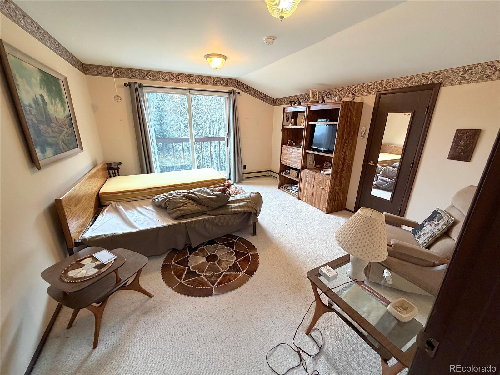 2508 Witter Gulch Road Evergreen, CO 80439 - Photo 37 of 47 a living room with furniture and a window