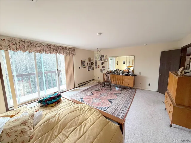 a bed room with a bed and a chair